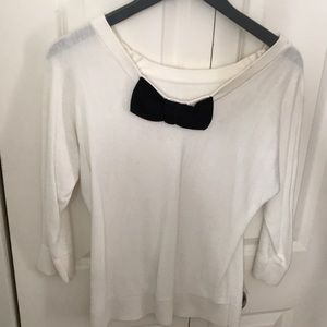 White sweater with a black bow in back